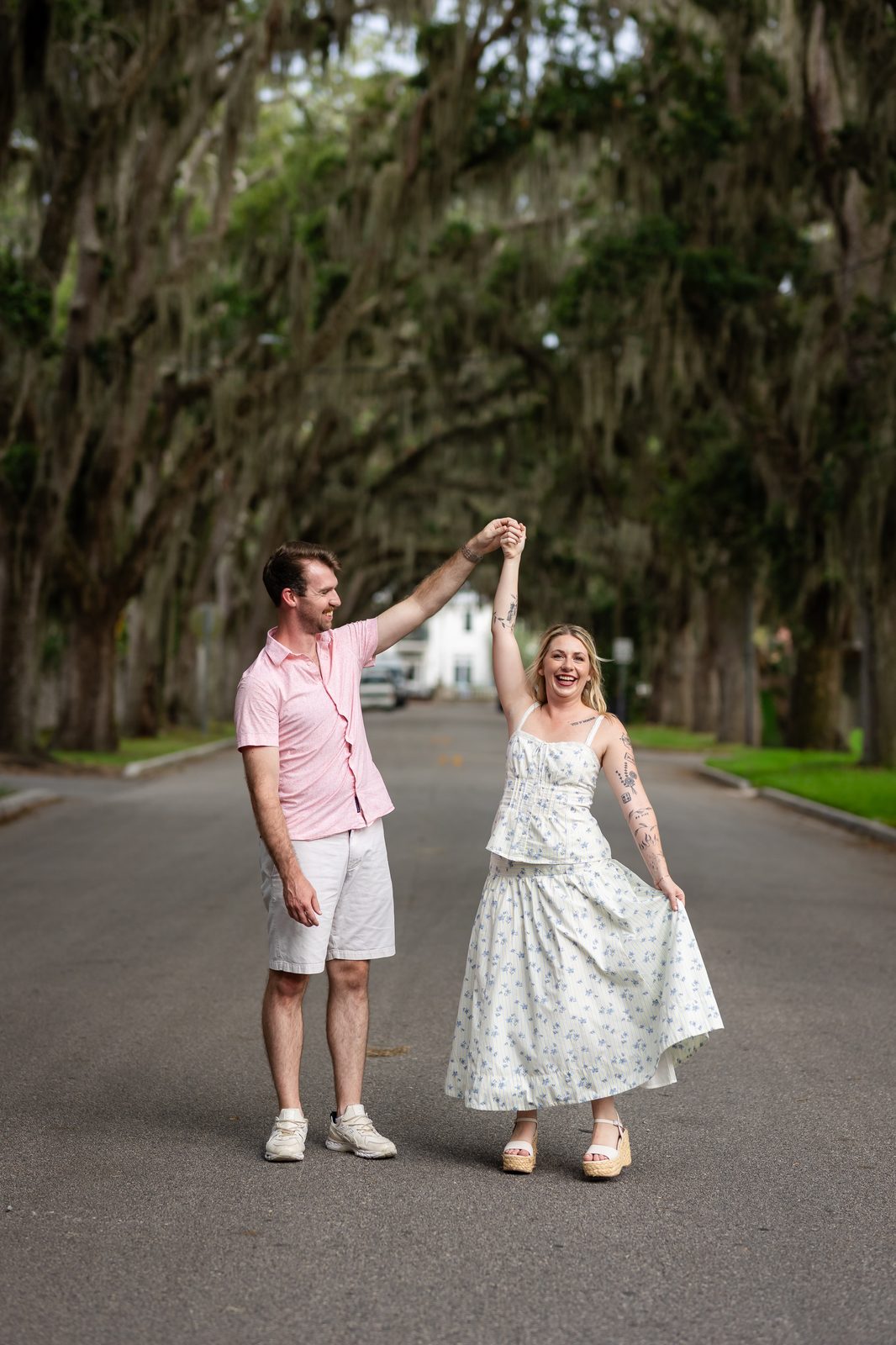 Ashlyn and Tyler dancing together under an oak canopy
